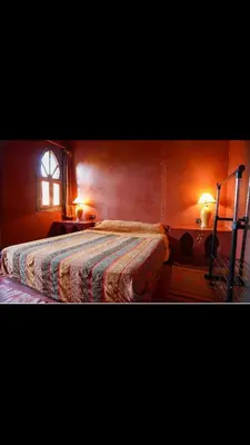 a bedroom with a large bed and a window at RIAD SYMPA dans residence in Marrakech