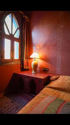 a bedroom with a bed and a lamp on a table at RIAD SYMPA dans residence in Marrakech