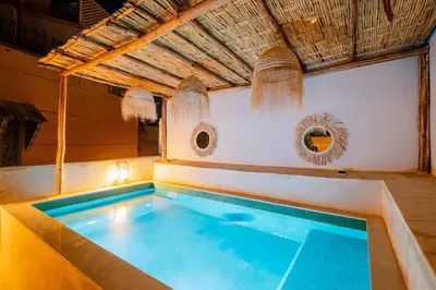 a indoor swimming pool in a building with a pool at Riad Sohayna with Rooftop Pool 3BR Oasis in Marrakech