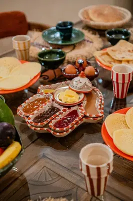 a table with plates of food on top of it at Riad Sohayna with Rooftop Pool 3BR Oasis in Marrakech