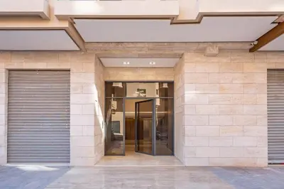 a building with two garage doors in front of it at Magnifique appt Hivernage Gueliz in Marrakech