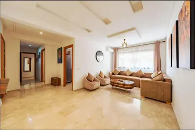 a living room with a couch and a table at gueliz central & Moderne in Tamazouzte