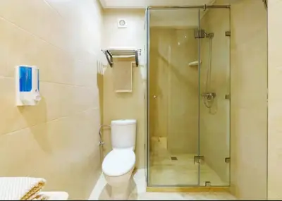 a bathroom with a toilet and a glass shower at gueliz central & Moderne in Tamazouzte