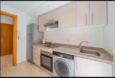 a kitchen with a sink and a dishwasher at gueliz central & Moderne in Tamazouzte