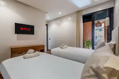 two beds in a hotel room with a sign on the wall at Élégance et Confort au Centre de Marrakech - Hivernage in Marrakech