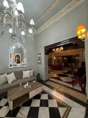 a living room with a couch and a chandelier at Golf mountain camels sereine holiday treat in Marrakech