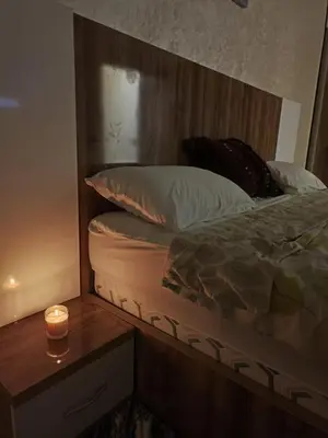 a bedroom with a bed with a candle on a table at arrive as a guest , turn to a local in Marrakech
