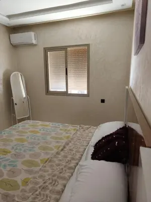 a bedroom with a bed and a window at arrive as a guest , turn to a local in Marrakech