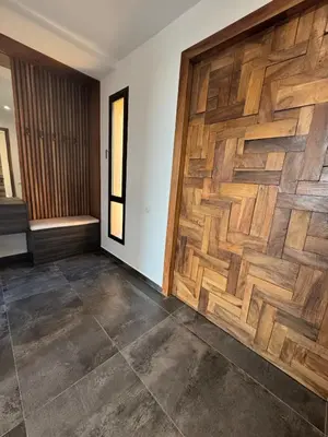 a room with a wooden wall with a wooden door at Prestige home