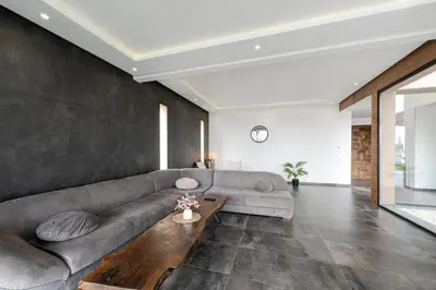 a living room with a couch and a table at Prestige home