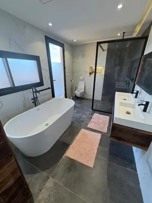 a large bathroom with a large tub and two sinks at Prestige home