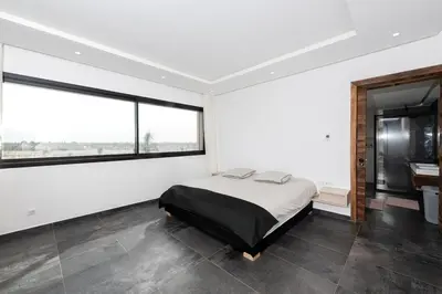 a bedroom with a bed and a large window at Prestige home