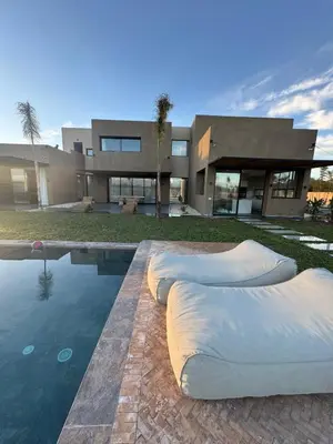 a house with two inflatable pillows in front of a swimming pool at Prestige home