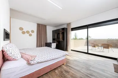 a bedroom with a bed and a large window at Prestige home