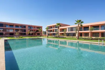 a large swimming pool in front of a building at Amal Cozy - Modern Design, 4 Pools & HD Wifi in Marrakech