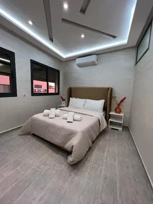 a bedroom with a large bed with two towels on it at Chic appartement Marrakech in Marrakech