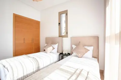 two beds sitting next to each other in a bedroom at The Calm Haven - Marrakech - Prestigia in Marrakech