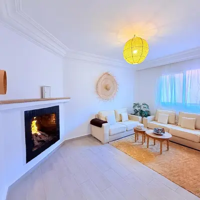 a living room with a couch and a fireplace at Meriso Downtown Free Parking in Marrakech