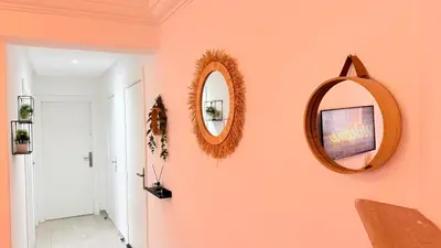 a hallway with two mirrors on a pink wall at Meriso Downtown Free Parking in Marrakech