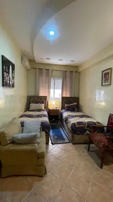 a living room with two beds and a couch at Appartement Marrakech Gueliz in Marrakech