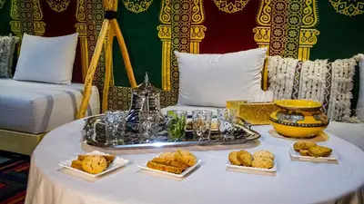 a table with a tray of food on it at Riad ELJazouli in Marrakech