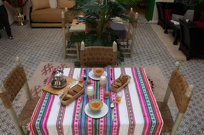 a table with a plate of food on it at Riad ELJazouli in Marrakech