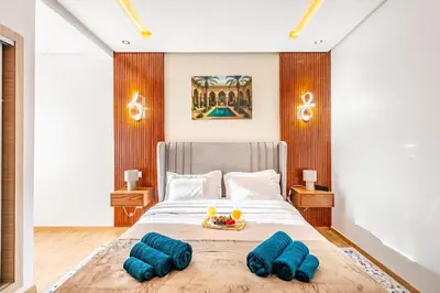 a bedroom with a large bed with blue pillows at Guéliz I Blue Mirage I Crafts and modernity in Marrakech
