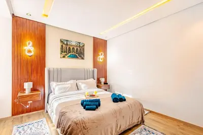 a bedroom with a bed with blue pillows on it at Guéliz I Blue Mirage I Crafts and modernity in Marrakech