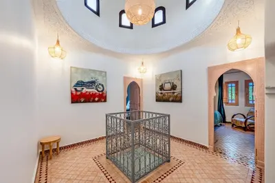 a living room with a staircase and a ceiling at Villa Chahrazad - 8prs - Piscine - Wifi in Marrakech