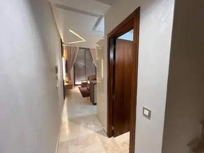 a hallway with a wooden door and a room at Elegant duplex Marrakech in Marrakech