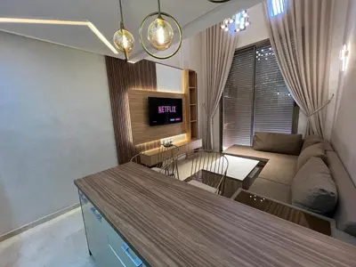 a kitchen and living room with a couch and a table at Elegant duplex Marrakech in Marrakech