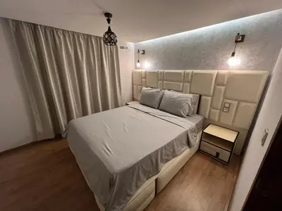 a bedroom with a large bed with white sheets at Elegant duplex Marrakech in Marrakech