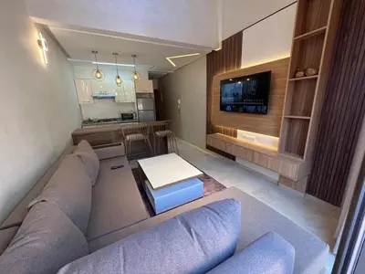 a living room with a couch and a tv at Elegant duplex Marrakech in Marrakech