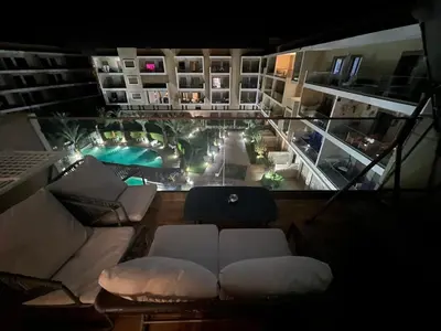 a view of a living room with a couch and a pool at Modern apartment with pool view, Kech in Marrakech