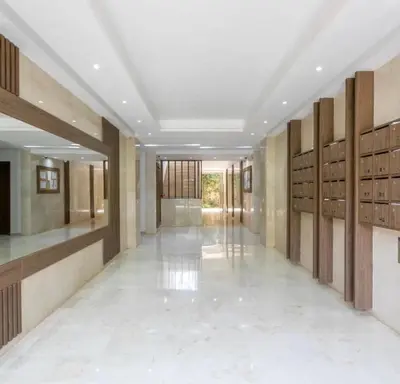 a hallway with wooden lockers in a building at Modern apartment with pool view, Kech in Marrakech