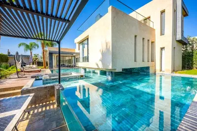 a swimming pool in front of a house at Palais Mahora in Marrakech
