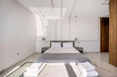 a bedroom with a large bed in a white room at Palais Mahora in Marrakech
