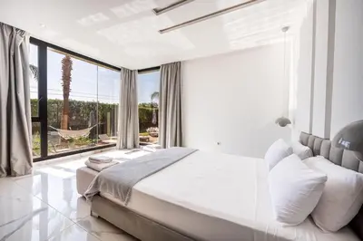 a bedroom with a large bed and a large window at Palais Mahora in Marrakech
