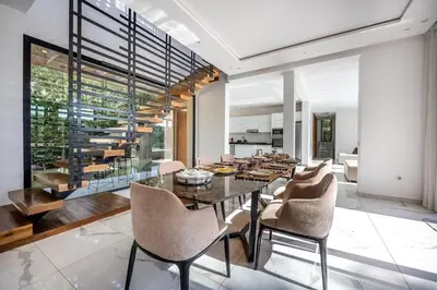 a dining room with a glass table and chairs at Palais Mahora in Marrakech