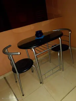a table with two chairs and a blue bowl on top at Apartment near Mènera gardens and city center in Marrakech