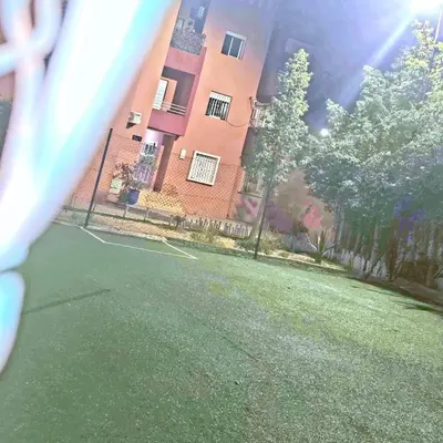 a view of a tennis court in front of a building at Apartment near Mènera gardens and city center in Marrakech