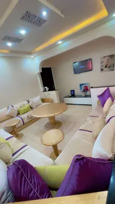 a living room with a couch and a table at Apartment near Mènera gardens and city center in Marrakech