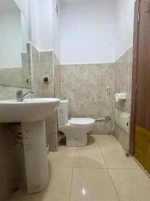 a bathroom with a white toilet and a sink at Apartment in Marrakech near McDonald's Massira in Marrakech