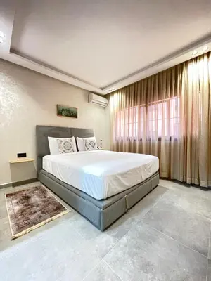 a bedroom with a large bed and a window at MayyRakech in Marrakech