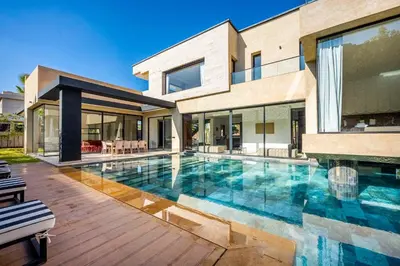 a swimming pool in front of a house at Palais Zahira in Marrakech