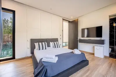 a bedroom with a large bed and a television at Palais Zahira in Marrakech