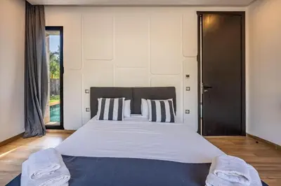 a bedroom with a large bed with two pillows at Palais Zahira in Marrakech