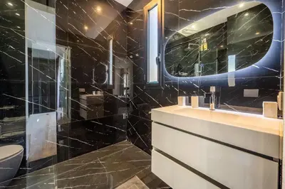 a bathroom with a sink and a toilet and a mirror at Palais Zahira in Marrakech