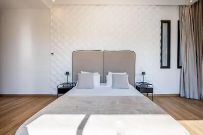 a bedroom with a large bed with white pillows at Palais Zahira in Marrakech