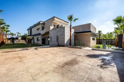 a large driveway in front of a house with palm trees at Palais Zahira in Marrakech